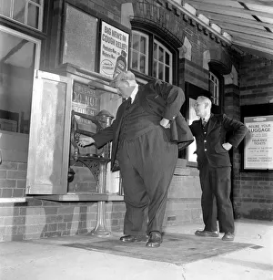 Fat Man John Feathestone seen here buying a ticket at his local railway station