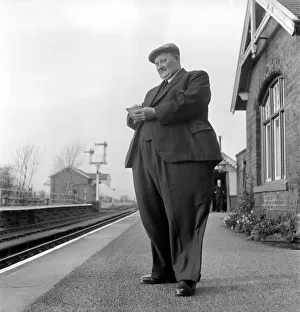 00039 Prints: Fat Man John Feathestone seen here buying a ticket at his local railway station