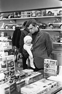 Department Store Prints: Father and baby son browse the latest Lego sets in the toy department of Heelas