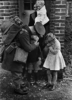 Brother Prints: A father called up for war service bids farewell to his children and wife. Circa 1939
