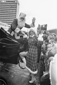 Father Christmas seen here helping his assistant into a horse drawn carriage after