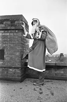 00888 Prints: Father Christmas seen here on the roof of Wellsteed department store in Broad Street