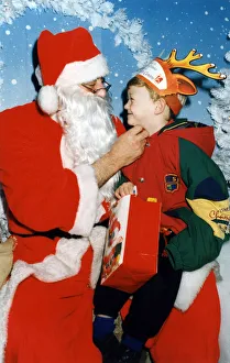 Santa Prints: Father Christmas and five year old Kenneth Andrew Dickons of Middlesbrough samples