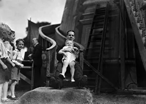 Fairground Prints: father and young son enjoy a ride on the Helter Skelter at the Tolworth Fun Fair in 1934