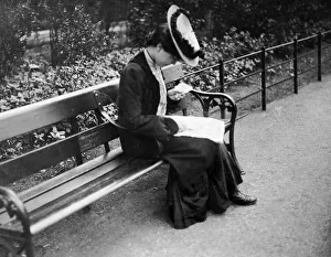 Victorian Prints: A female bus passengerchecks her used ticket as she sits on abench after descending