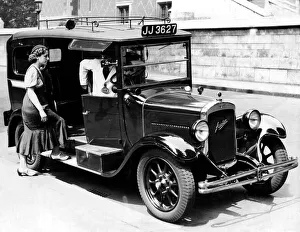 Cab Driver Prints: A female passenger entering one of the new London taxi cabs that can travel up to 50