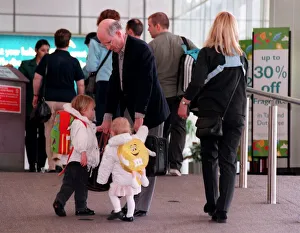 Fergus McCann and family at Glasgow Airport April 1999 taking hold of his