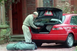 Amca Prints: Fergus McCann packs his belongings into the boot of his Mercedes April 1999 as he