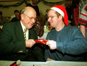 Amca Prints: Fergus McCann pulls a cracker with Craig who Aattended a lunch for the homeless at St