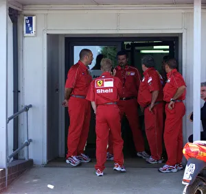 01372 Prints: Ferrari team members rush to the medical centre for news on Michael Schumacher