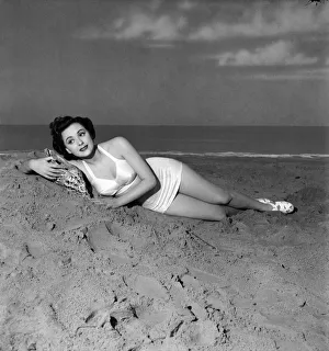 Film star Lara Morris in new bathing costume made of white satiri and elastic