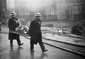 Fire crews, police and Air Raid Precaution (ARP) wardens help salvage furniture