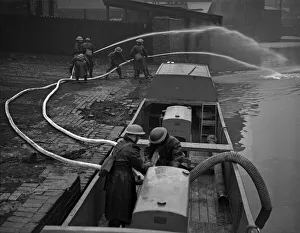 Fire Float Practice. Members of the Birmingham Auxiliary Fire Service Naval Detachment