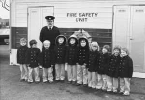 00072 Prints: Fire safety unit Sub officer Graham Shiel with children at Southridge First Shcook
