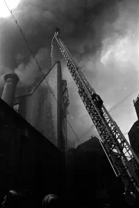 Hose Prints: Firefighter tackle a fire following the V1 bombing of Brown Brothers in Great Eastern