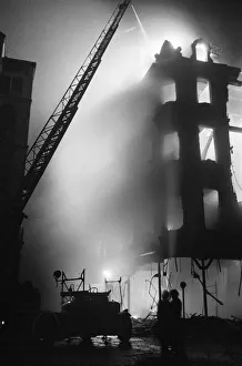 Firefighters of the Auxiliary Fire Service attend the scene of the blazing 50 Shilling