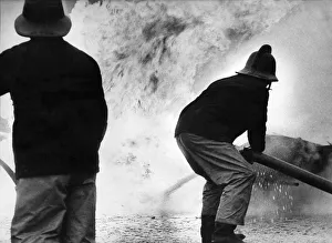 Firefighter Prints: Two firefighters battle to contain the flames at the petrol tank blaze