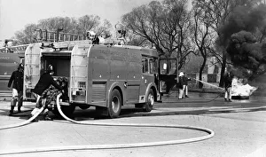 00072 Prints: Firefighters in the latest fire engine fight to get a blaze under control