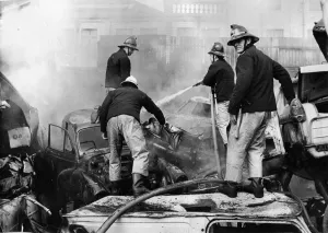 00074 Prints: Firefighters scrambled about on piles of old cards to tackle a fire at Benfield Vehicle