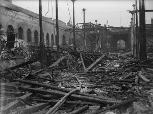 Fireman dampen down and sift through the burnt out shell of the Birmingham Market Hall