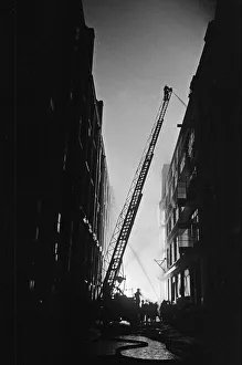 01496 Prints: Firemen attempt to control fires in Shoreditch, London, during an air raid on the city