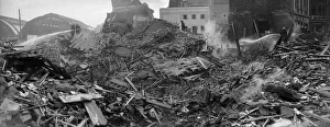 Firemen dampen down the shattered remains of John Bright Street, Birmingham