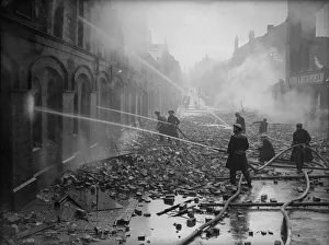 Firemen dampening down fires in Moseley Street, Birmingham the morning after a heavy
