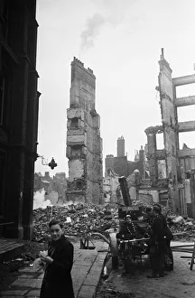 01491 Prints: Firemen dampening down the smouldering ruins in the the City of London following
