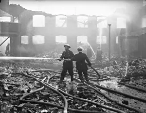 Hosepipe Prints: Firemen seen here dampening down fires in the Holbrooks area of Coventry following