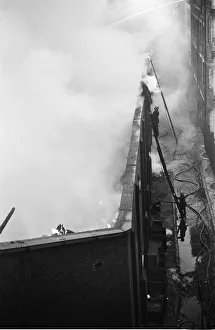 01499 Prints: Firemen tackling a fire at Taylors Great Central Depository in St Georges Road