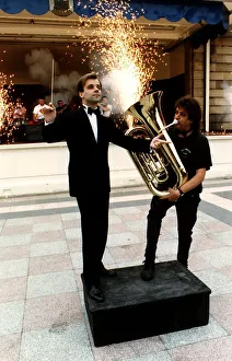 Fireworks director Wilf Scott plays a tuba in front of orchestra conductor Christopher