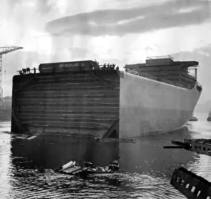 The first half of a 46, 000 ton ship was launched today without ceremony yesterday