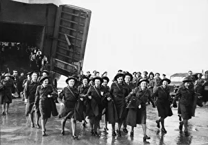 The first party of ATS attached to the 21st Army Group seen here coming ashore from a