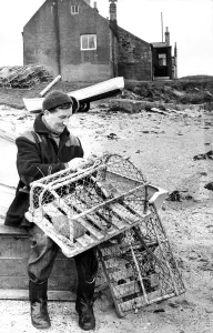 Fisherman Prints: Fisherman George Green fixing lobster pots on the beach at Boulmen in 1970