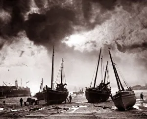 Fishermen off-load nets for repair and carry out essential maintenance to their boats