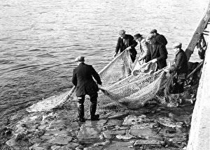 Fishermen Prints: Fishermen on the River Tweed in Berwick hauling their net ashore after trying to catch