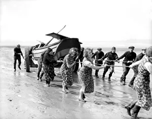 Fisherwomen of New Biggin, England hauling their boat ashore Women fulfilling Mens