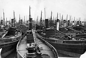 Boats Prints: Fishing boats seen here tied up and deserted in Lowestoft harbour after a busy