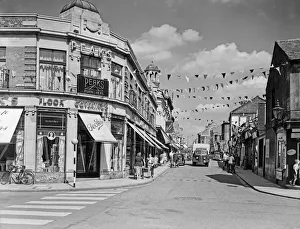 Flags fluttering in the breeze, decorations in traditional colours lining the streets