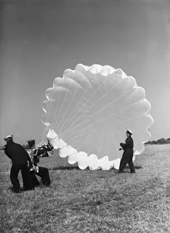 01479 Prints: Fleet Air Arm parachute packers seen here testing a parachute at an un-named Royal Naval