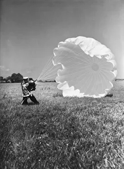 01479 Prints: Fleet Air Arm parachute packers seen here testing a parachute at an un-named Royal Naval