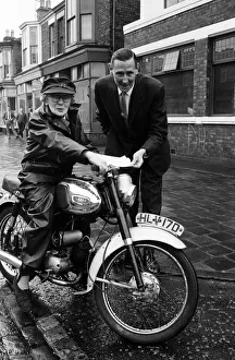 Yamaha Prints: Florrie Ball, 77, is given a cover note for her insurance for her motorbike insurance by