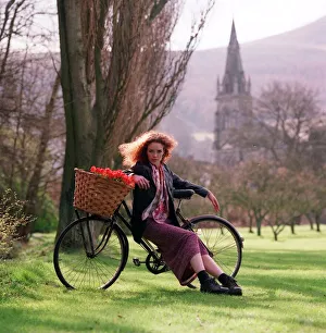 Flower power fashion feature 1998 girl in gardens country side bike basket trees