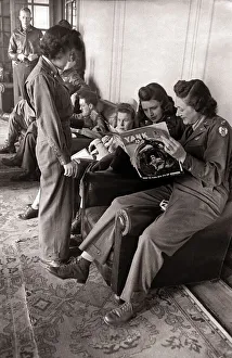 00190 Prints: US flying nurses using the officers lounge reading a magazine from home The nurses are