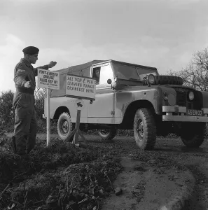 Diseases Prints: Foot and Mouth Disease Outbreak November1967 A soldier being directed to wash down