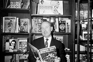 01216 Prints: Football agent Ken Stanley reading a George Best annual. 18th February 1970