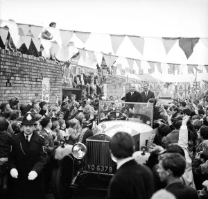 Bunting Prints: Football brothers Jack and Bobby Charlton are mobbed by crowds after leaving their