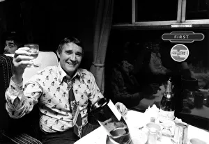Drink Prints: Football manager Malcolm Allison drinking champagne n the train