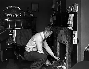 Footballer Billy Wright Wolves and England captain seen here putting coal on the fire