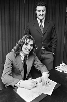 Footballer Robin Friday with Reading FC manager Charlie Hurley after signing a